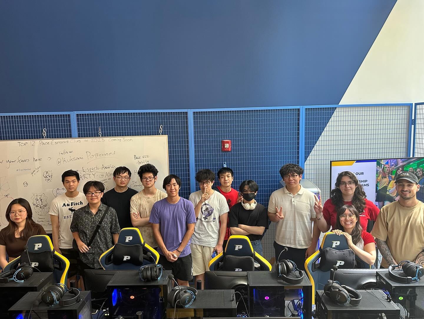 Players and organizers group photo behind the gaming chairs after the playoffs.