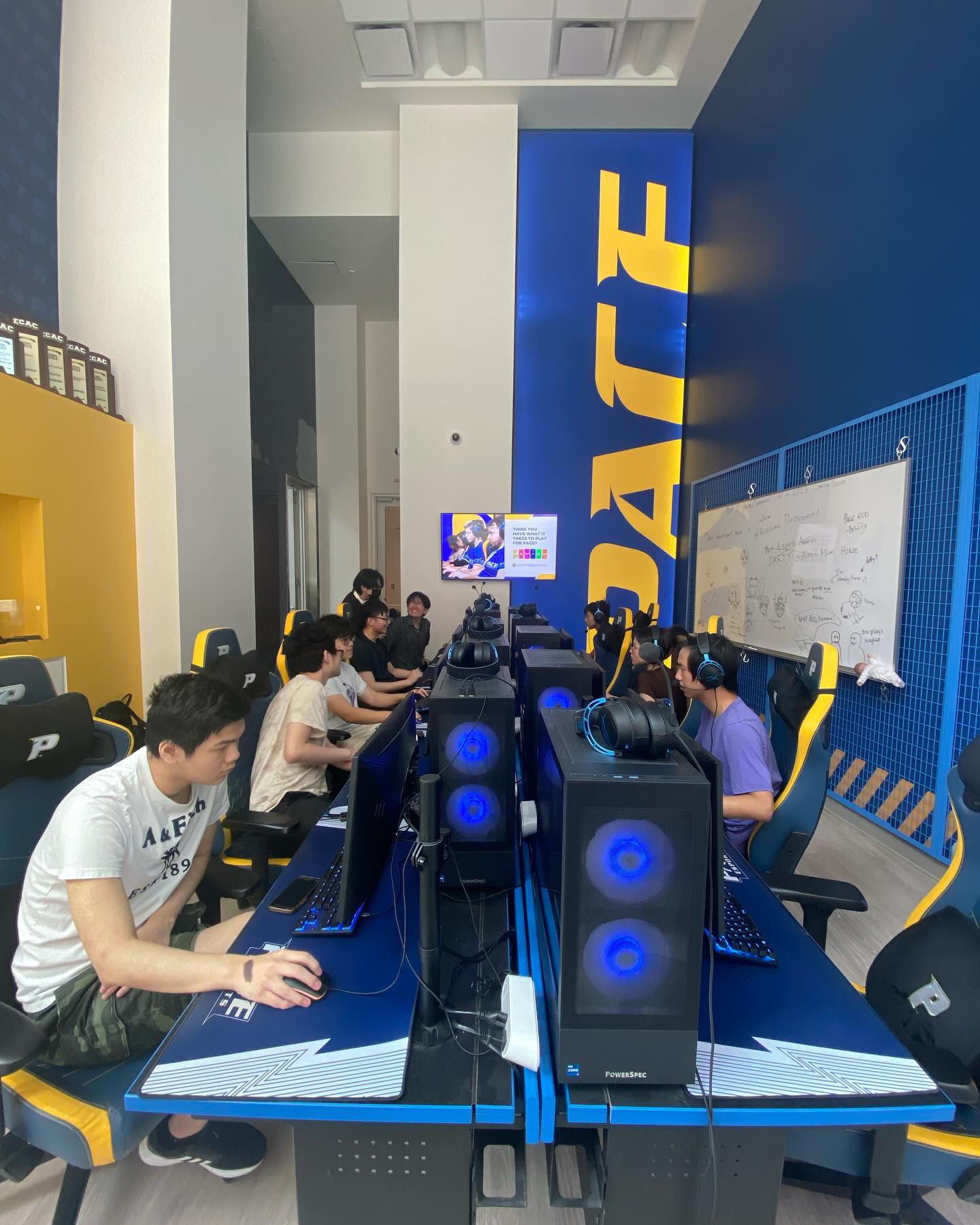 Wide shot of competitors locked in at their gaming stations inside the Pace University esports arena