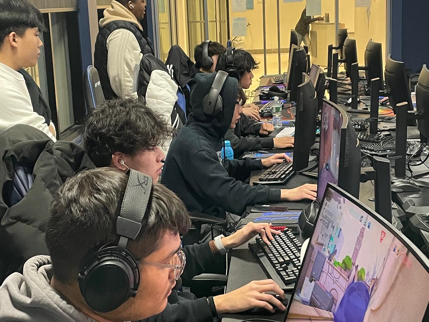 Players locked in during a round, headsets on, mid-match.