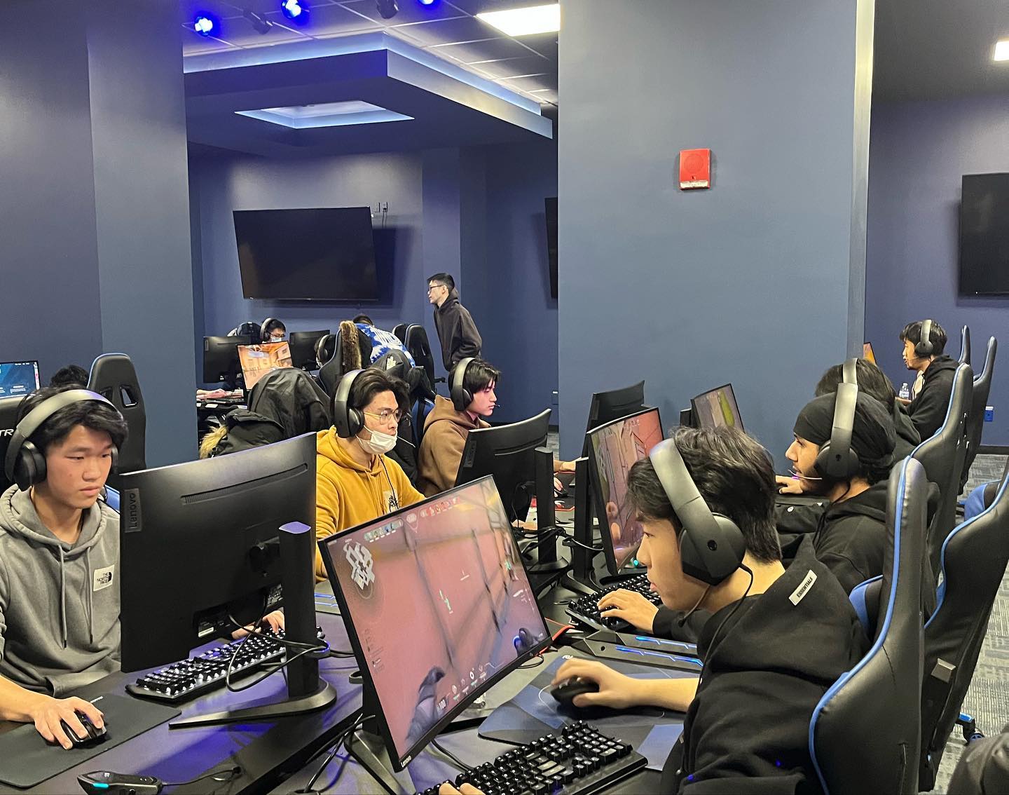 Row of players competing at their PCs, headsets on