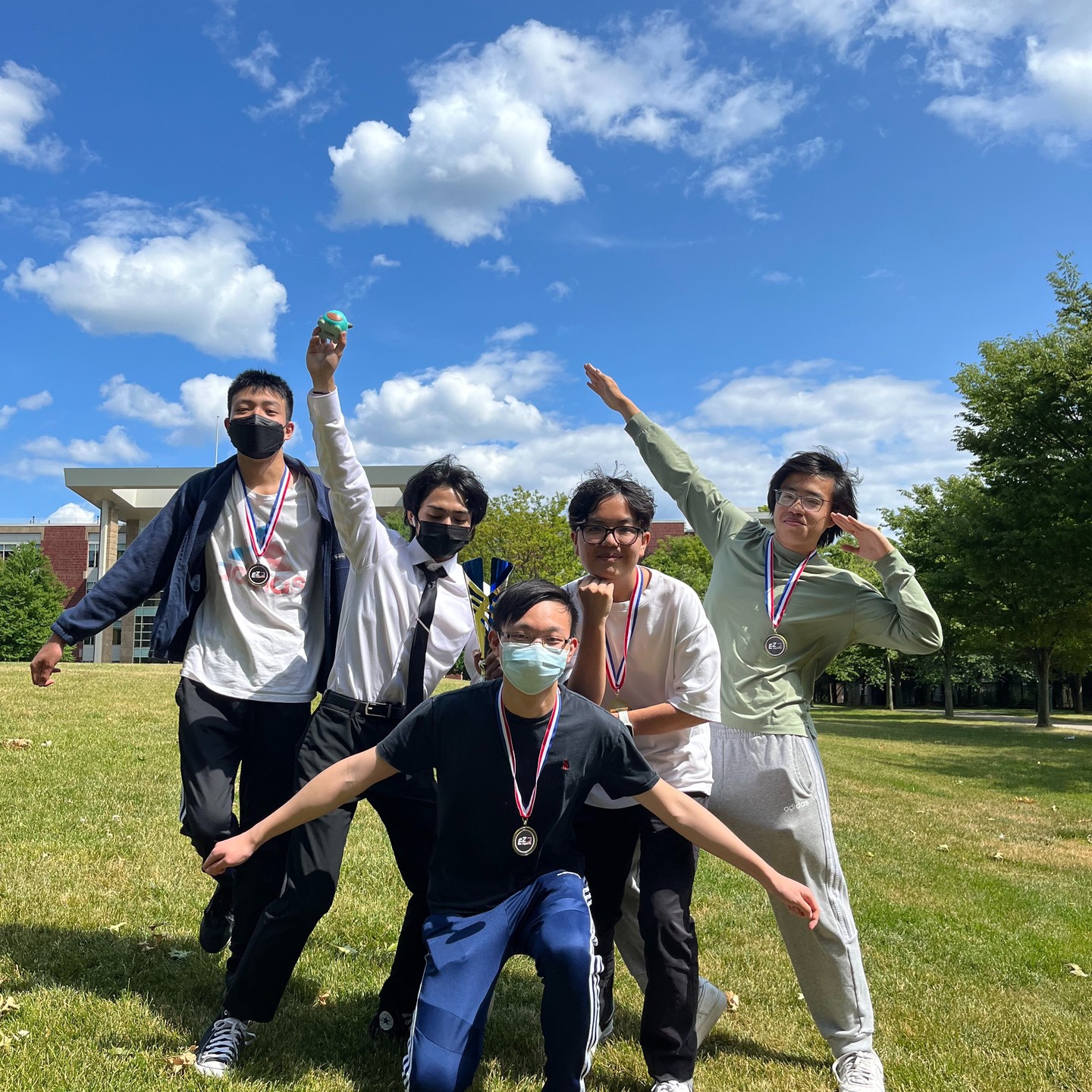The four TFT winners posing outdoors on the Wagner College lawn with their medals
