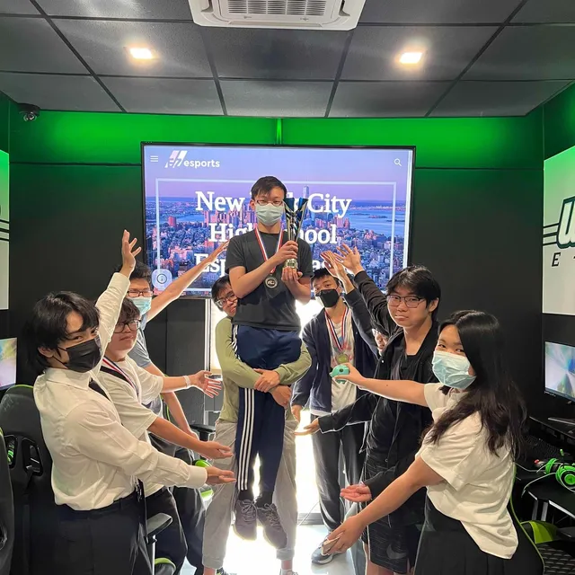 A winner lifted up and celebrated by teammates in the Wagner College esports lounge